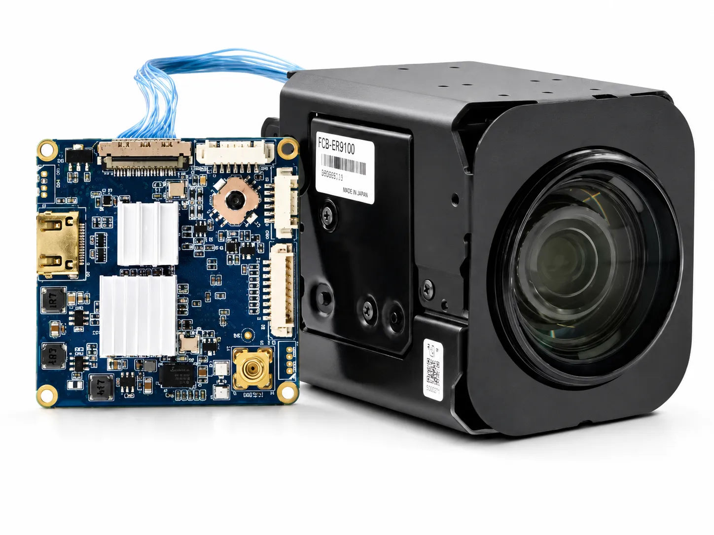 FCB-ER9100 camera, shown alongside a interface board with connecting cable