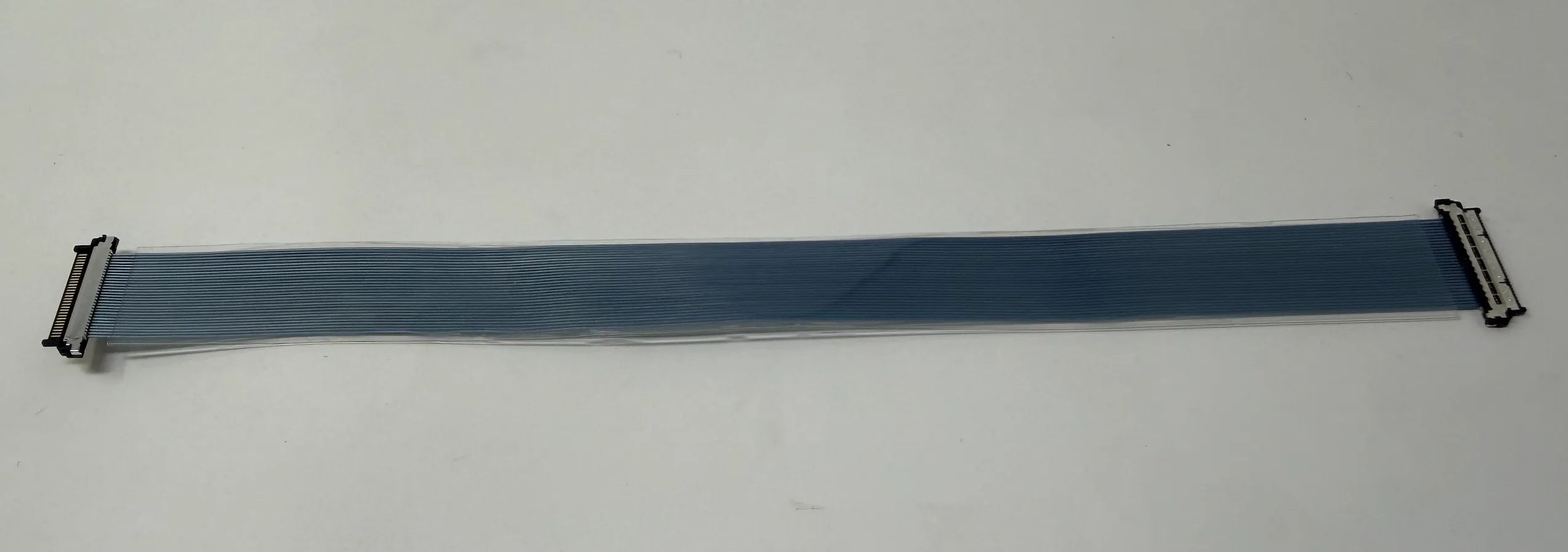 Blue ribbon micro coaxial cable on a white background