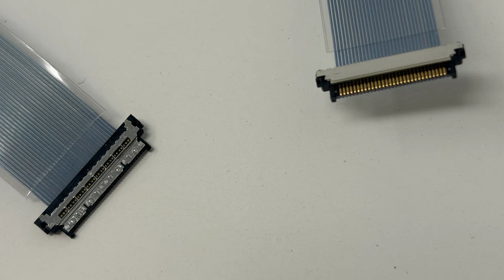 Two electronic micro coaxial connectors on a white background