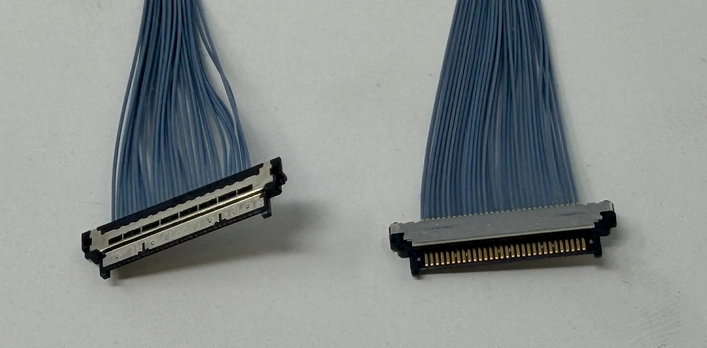 Two micro coaxial cable connectors on a white background